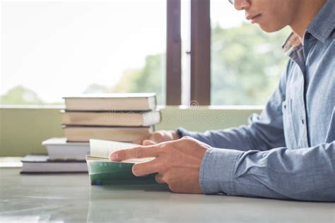 Business Man Reading A Book And Writing Notes On Table Stock Photo