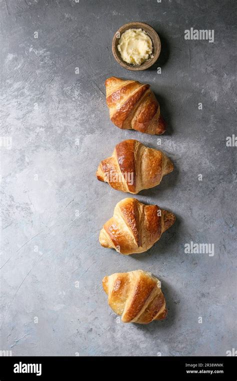 fresh baked traditional croissant  butter  row  grey texture