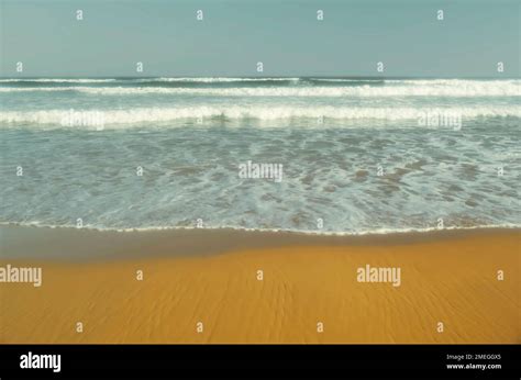 Incoming Whitewater Waves Rolling Onto A Sandy Beach Stock Photo Alamy