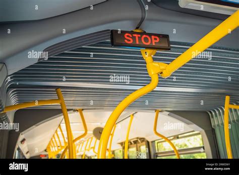 Stop sign in city bus. Empty bus interior. Bus with blue seats and yellow handrails Stock Photo ...