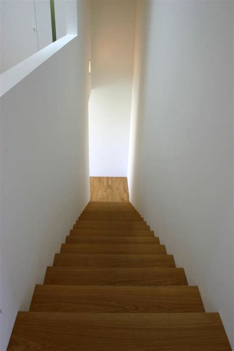 The Stairs Are Made Of Wood And Have White Walls