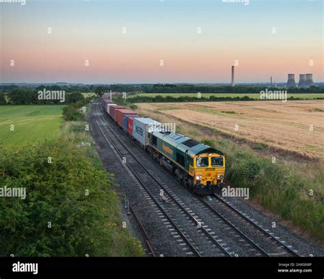 Freightliner Class 66 Diesel Locomotive 66566 Hauling A Train Of Deep Sea Shipping Containers