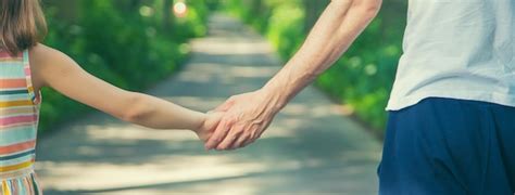 Premium Photo Cropped Image Of Father And Daughter Holding Hands