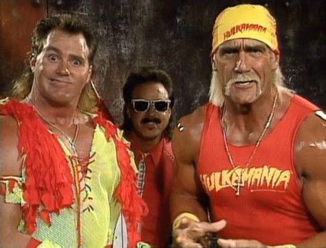 two men in red and yellow outfits standing next to each other with one man wearing sunglasses