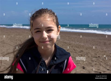 Young Girl Sits On The Beach Near By Blue Sea Stock Photo Alamy