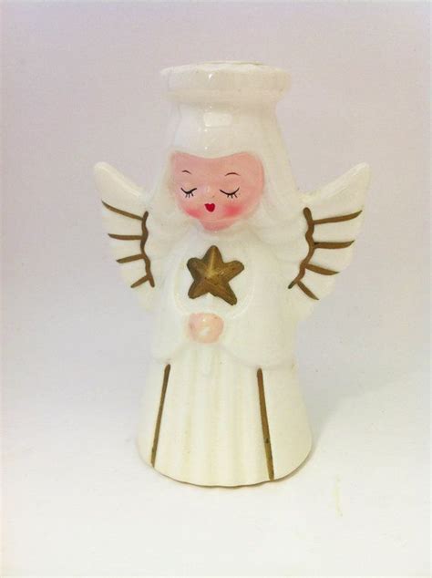 An Angel Figurine With Wings And A Star On Its Chest