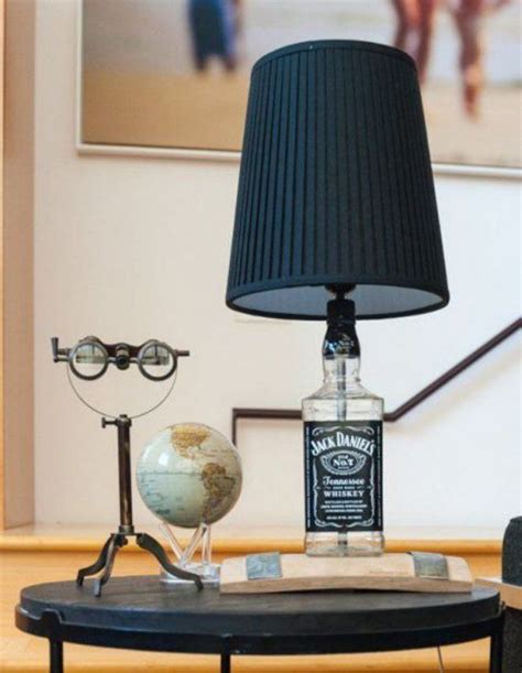 A Lamp That Is Sitting On Top Of A Table Next To A Globe And A Bottle