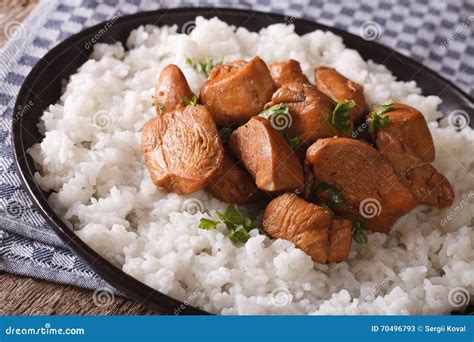 Adobo Chicken With Garnish Of Rice Close Up On A Plate Horizontal