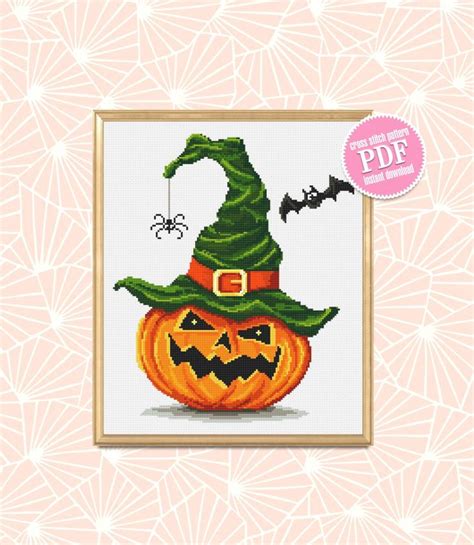 A Cross Stitch Halloween Pumpkin With A Witch Hat