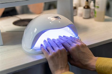 Premium Photo Uv Lamp Gel Polish Manicure Process A Woman Dries Her