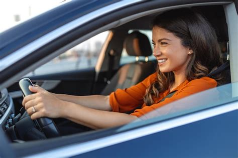 Premium Photo Happy Woman Driving A Car And Smiling Cute Young