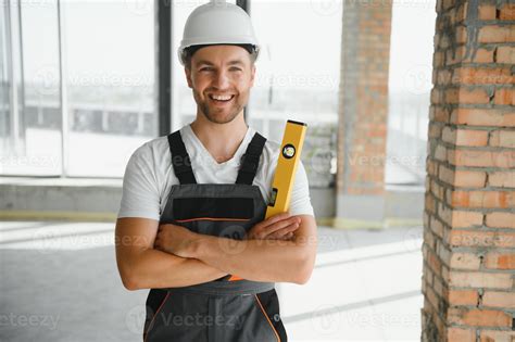 Man Builder Working In Construction Site Male Repairer In Overall And