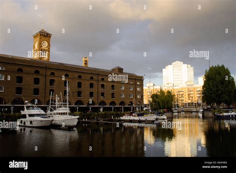 View Across St Katherines Dock With Dramatic Sky Sunset And Light In