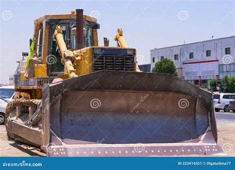 Front View To Huge Scoop Of Old Dirty Extremely Heavy Bulldozer Arrived