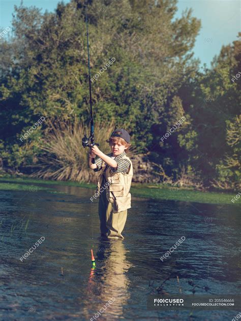 Little boy fishing in river — hobby, green - Stock Photo | #205546666