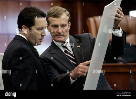 State Attorney John Tanner Right Shows Photographs To Be Submitted As