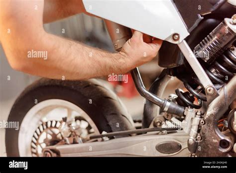 Mechanic Close Up Repairing Motorbike In Repair Garage Stock Photo Alamy