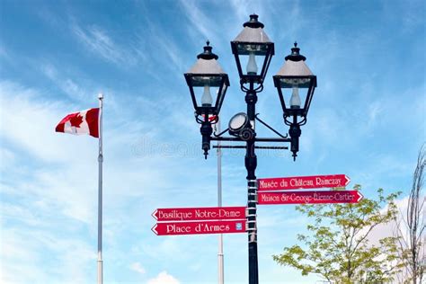 Red Arrow Street Signs Mounted on a Lamp Post with Canadian Flag in Montreal, Quebec, Canada ...