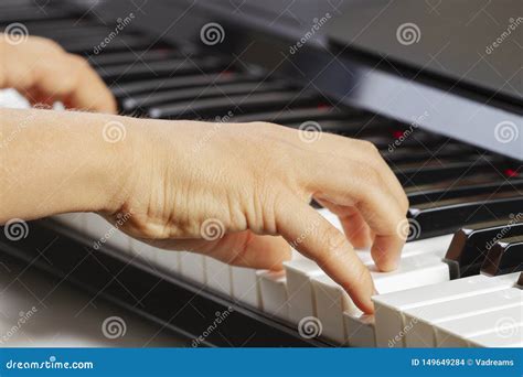 Close Up View Of Kid Hands Playing On Piano Keyboard Stock Photo