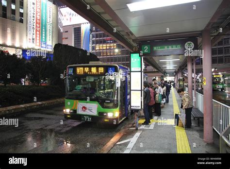 TOKYO, JAPAN - APRIL 13, 2012: People board Toei Bus in Shinjuku, Tokyo. Toei Bus is the main ...