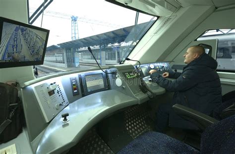 Man Train Driver Sitting In The Cabin Of Locomotive Of Passenger Train