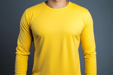 Premium Ai Image A Man In A Yellow Shirt Stands Against A Gray Background