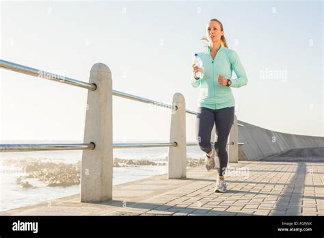 Focused Fit Blonde Jogging At Promenade Stock Photo Alamy