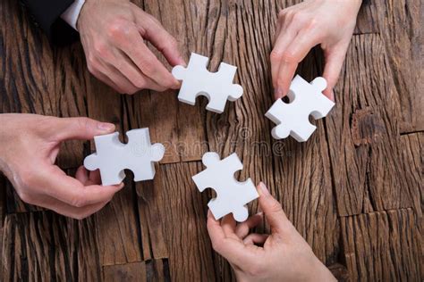 Group Of Businesspeople Solving Jigsaw Puzzle Stock Image Image Of