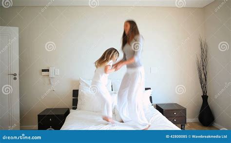 Mother And Daughter Jumping On A Bed Stock Video Video Of Daughter