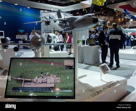 Exhibitors at Singapore Air Show displaying weapons systems Stock Photo ...