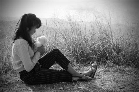 Premium Photo Black And White Of Alone Woman Sitting And Hug Teddy