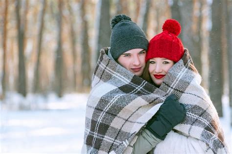 Premium Photo | Portrait of young couple in winter in snowy park guy ...