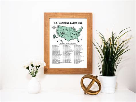 a framed map of the united states is displayed next to some potted ...