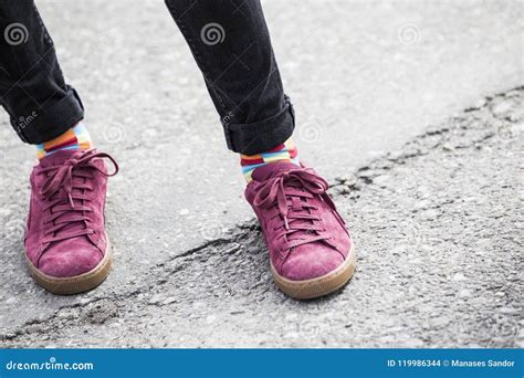 Pink Shoes And Rainbow Colored Socks On Men Marching At Gay Pride Stock