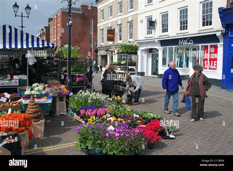 A Colourful Flower Stall On Market Day In The Market Square In Ludlow