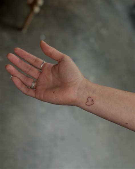 Minimalistic Style Airplane And Heart Tattoo Located On