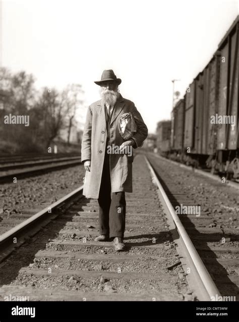 1930s Great Depression Era Man Homeless Hobo Walking Down Railroad