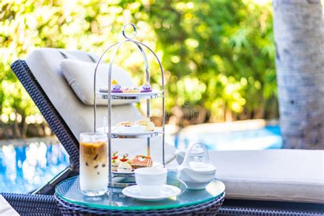 Afternoon Tea Set With Latte Coffee And Hot Tea On Table Neary Chair