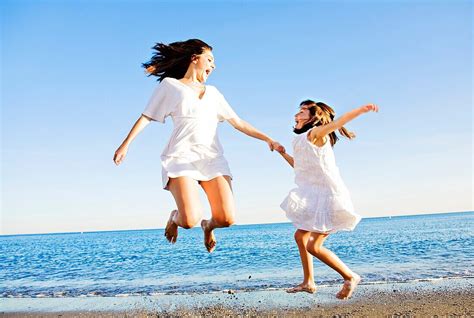 Mother And Daughter Jumping And Having … Bild Kaufen 70389135