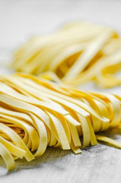 Premium Photo Homemade Pasta Tagliatelle On A White Table