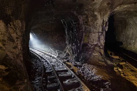 Dark Dirty Abandoned Uranium Mine With Rusty Remnants Of Railway