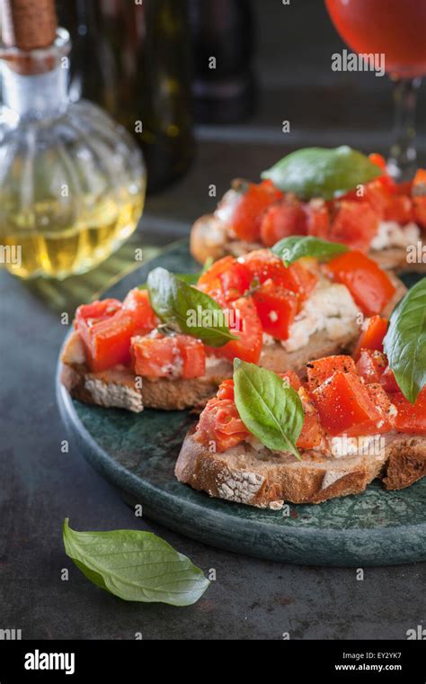 Italian Tomato Bruschetta With Basil And Olive Oil On Crusty Slice Of