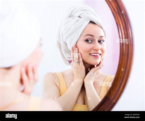 Young Woman Looking In The Mirror Stock Photo Alamy