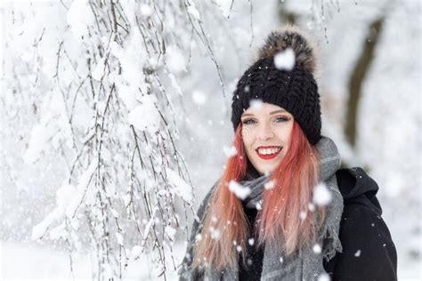 Portrait Of Attractive Red Hair Girl Under The Snowfall Stock Image