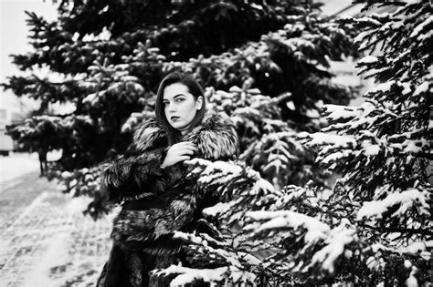 Free Photo Brunette Girl In Green Fur Coat At Winter Day Against Snowy Pine Tree