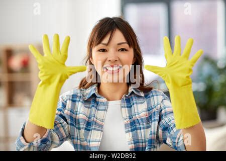 Asian Woman Wearing Yellow Rubber Glover With Cloth Rag And Detergent