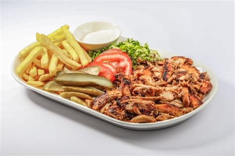 Premium Photo Chicken Shawarma Plate With Salad Fries Served In A