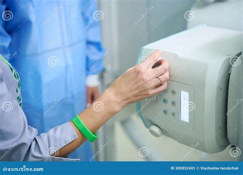 Experienced Radiographer Preparing Person For Radiographic Examination