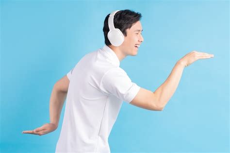 Premium Photo A Photo Of A Handsome Asian Man Listening To Music And