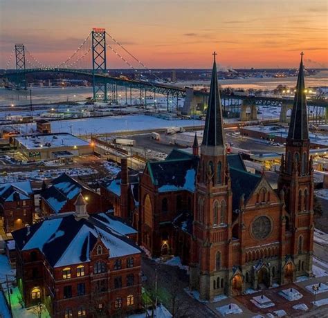 An Aerial View Of A City At Sunset With The Bay Bridge In The Back Ground